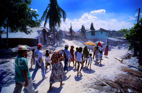 Refugees from Pinatuno’s eruption, residents of Porac, Pampanga, trudge past their ash smothered homes.