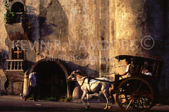 Kalesa ride past old Laog church, Ilocos Norte, Philippines